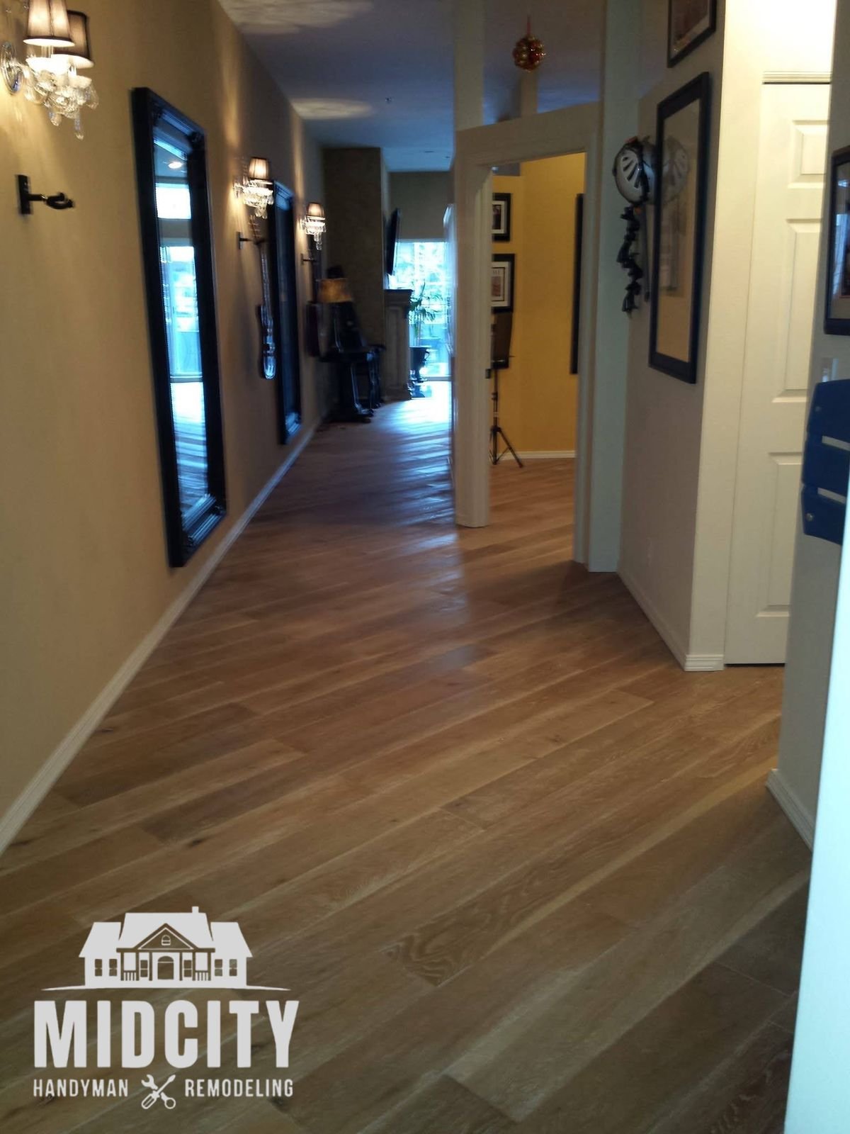 Wide plank flooring installed through a hallway by Midcity Handyman & Remodeling