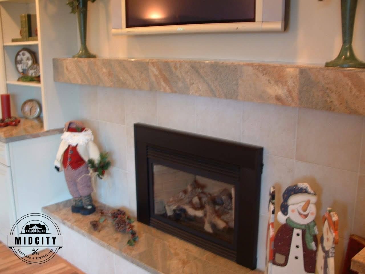 Custom fireplace built-in with stone surround and display shelving